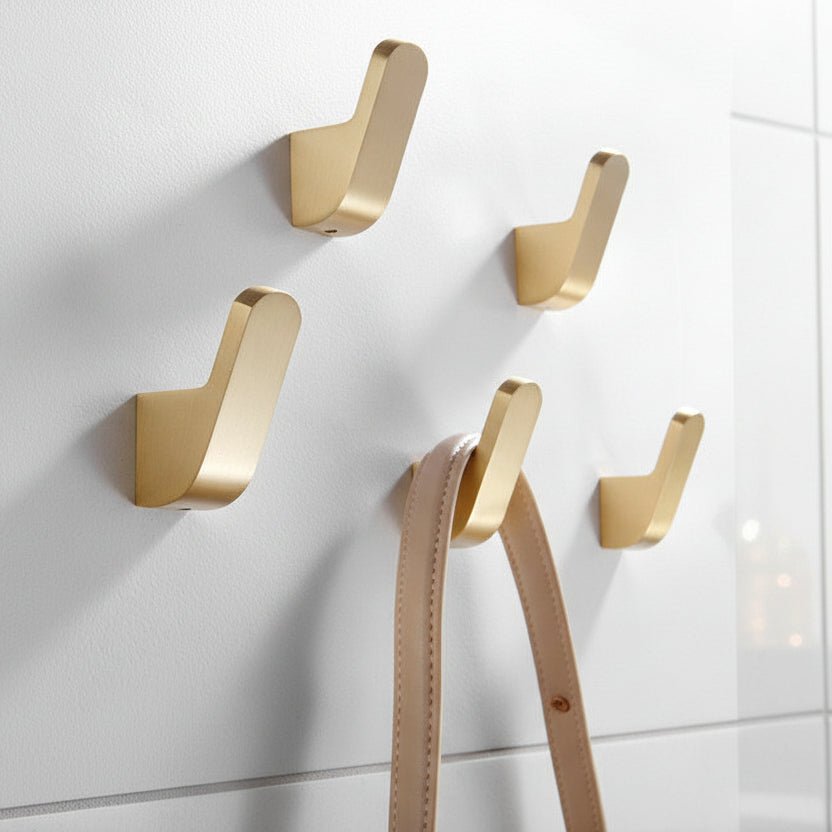 Modern golden brass wall hooks for bathrobes for compact and elegant hanging