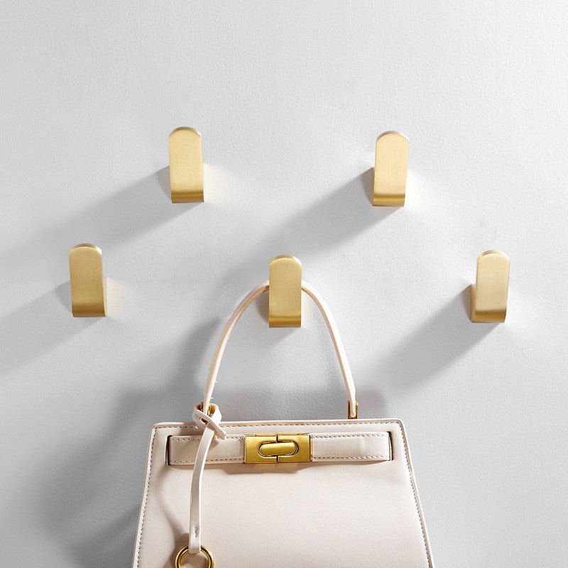 Modern golden brass wall hooks for bathrobes for compact and elegant hanging